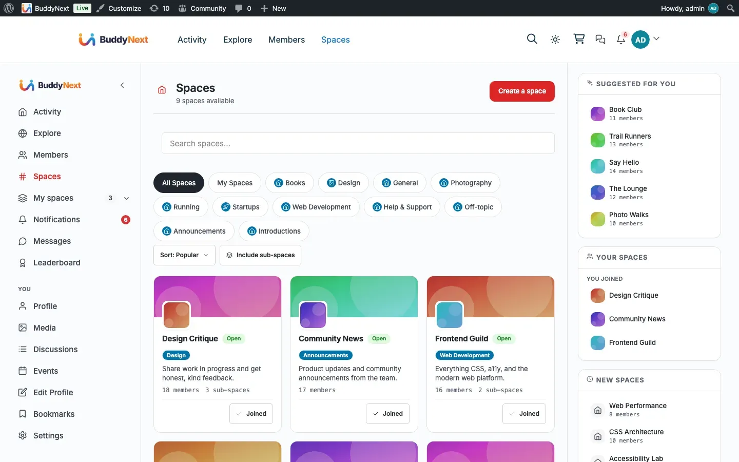 BuddyNext spaces directory — browse spaces by category with search and sort, an invite banner, space cards showing member and post counts, and Your Spaces and Trending Tags sidebars.